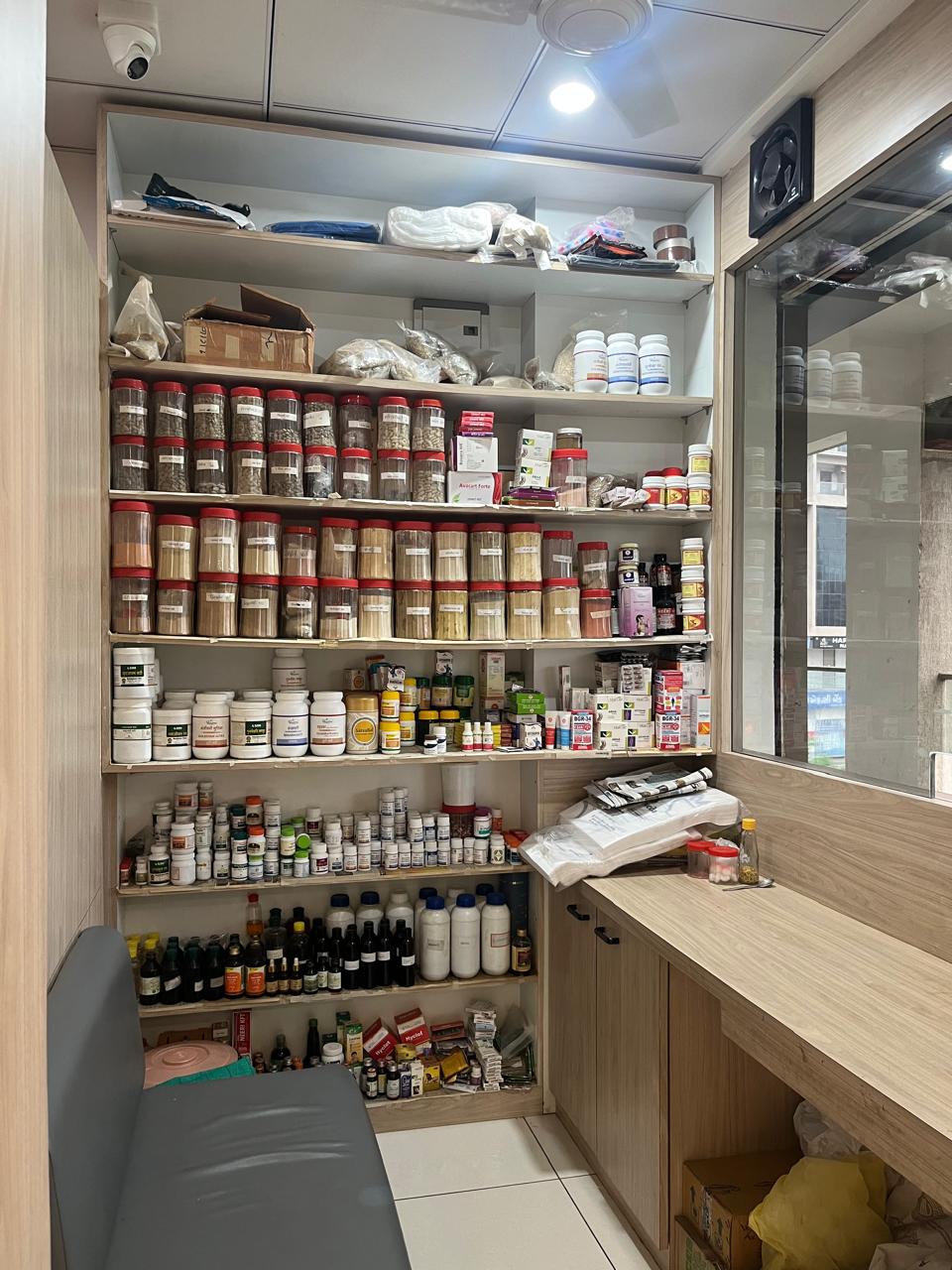 In-house Ayurvedic pharmacy shelves with herbal formulations